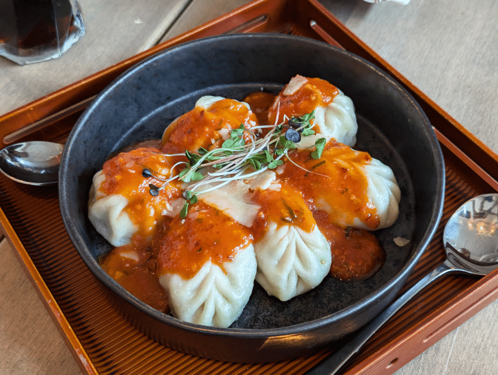 Nepalese momo dumplings in a delicious Italian Ariabatta sauce.